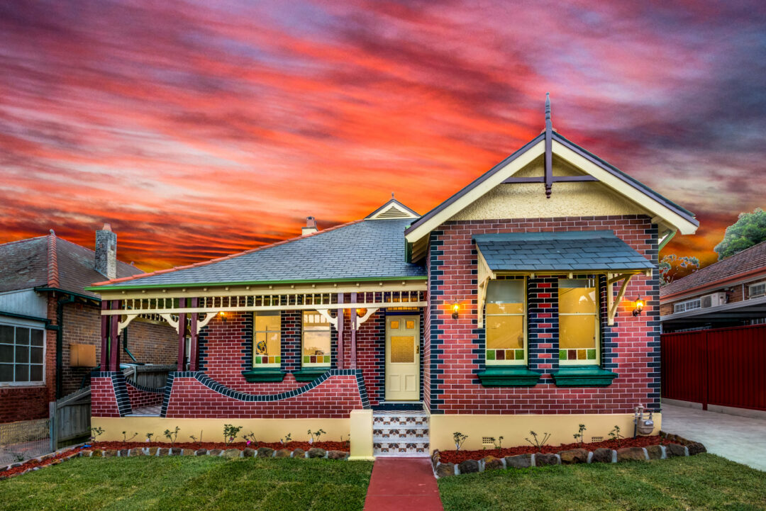 A colourful stunning house with green lawn in front