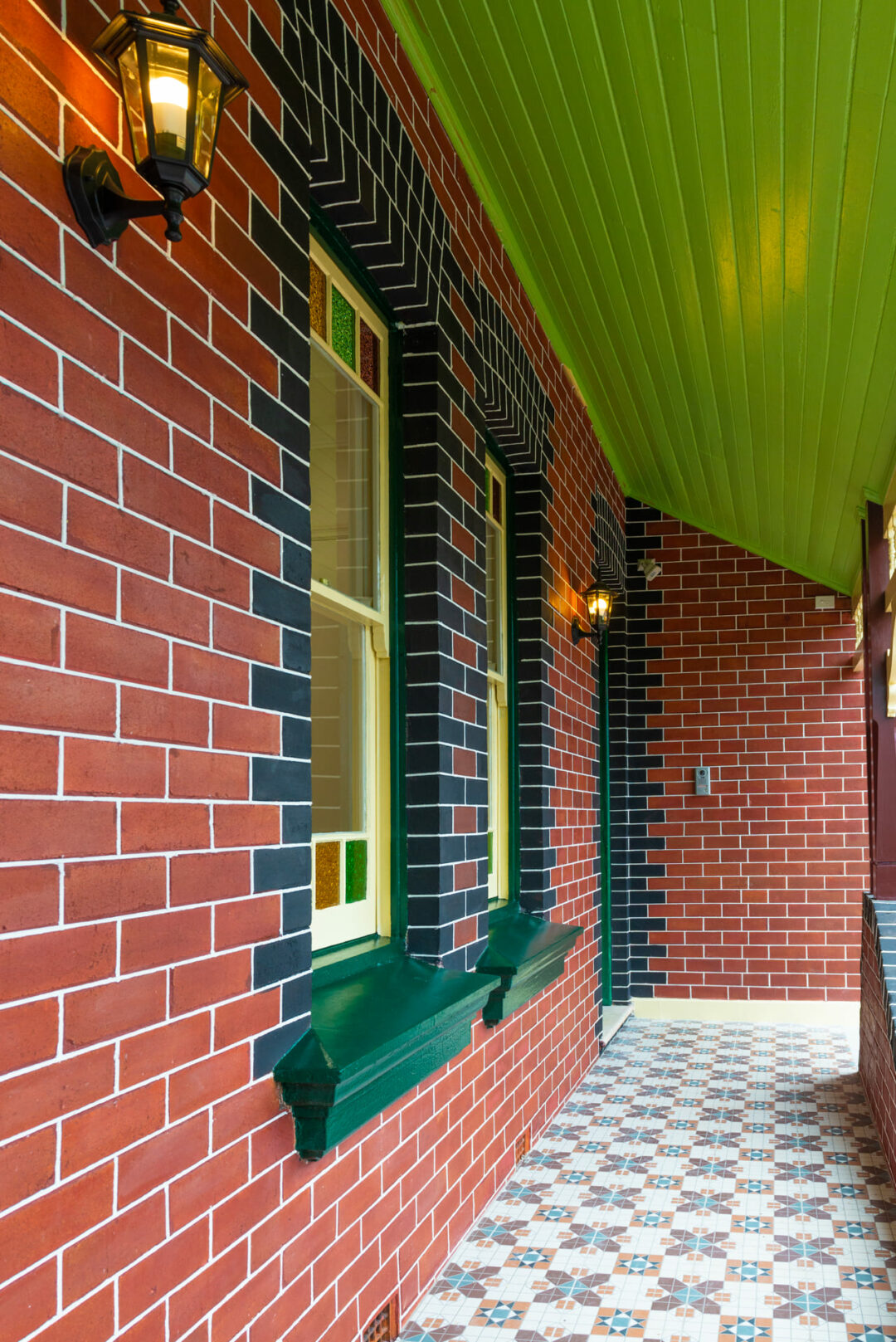 Red bricks wall with green roof