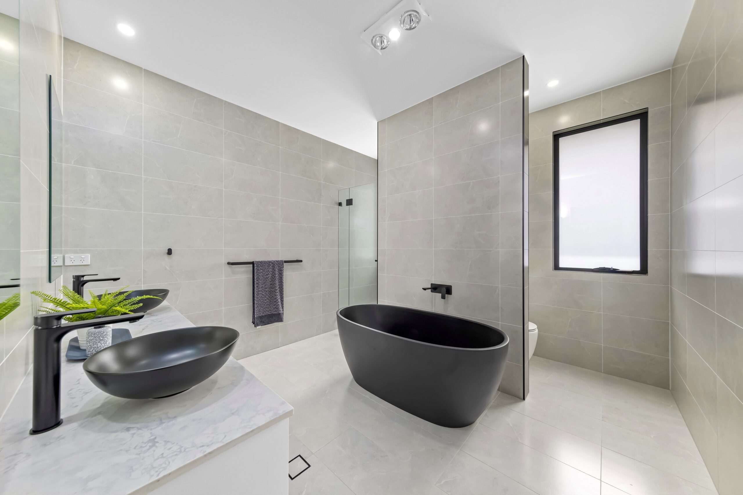 Luxury home bathroom with black tub sink and bathtub