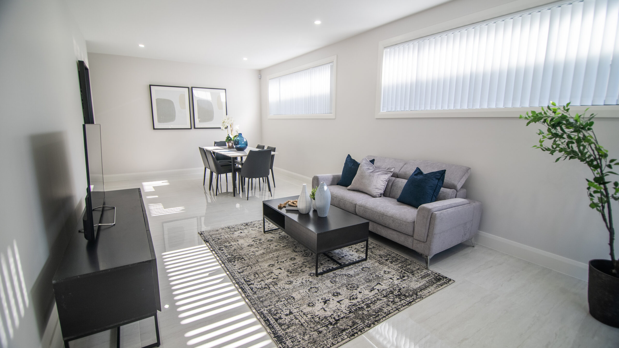 Sustainable living room with couch, TV cabinet and tables