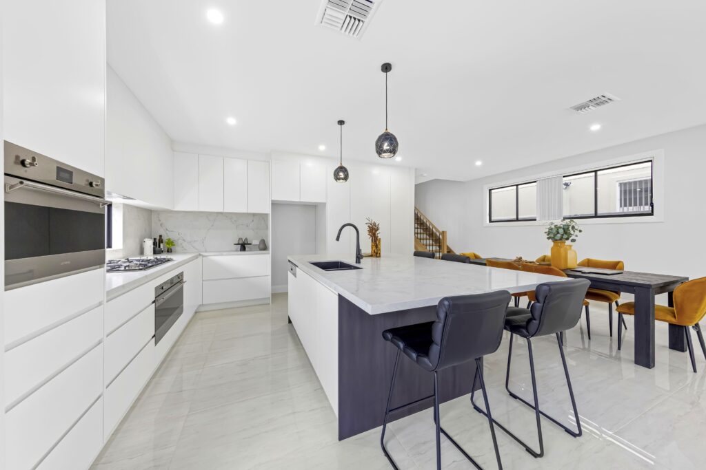 A kitchen with dining table and chairs