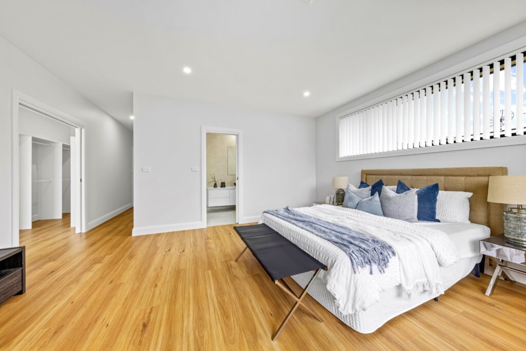 A bedroom with a bed and bench