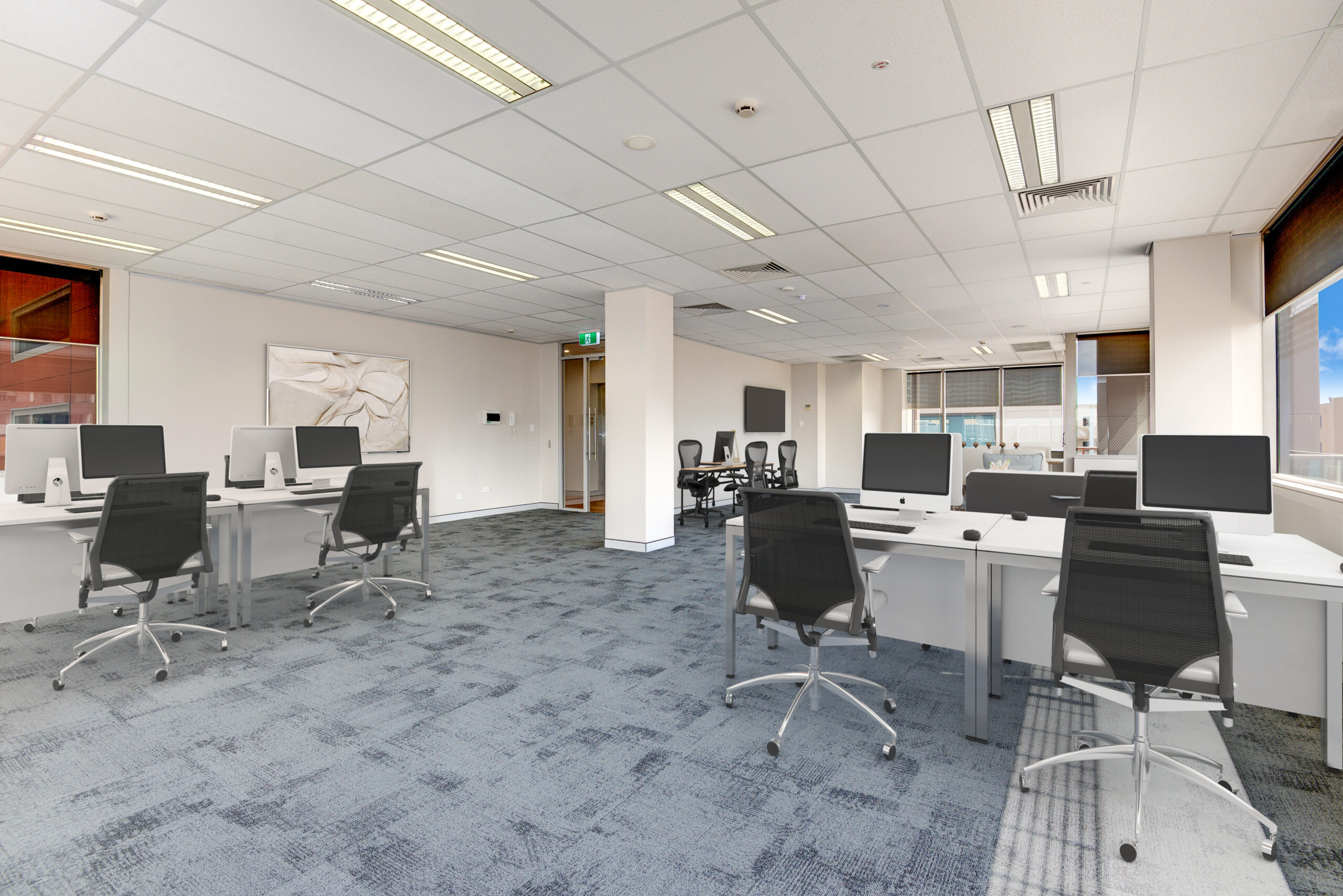 An empty office with computers and chairs