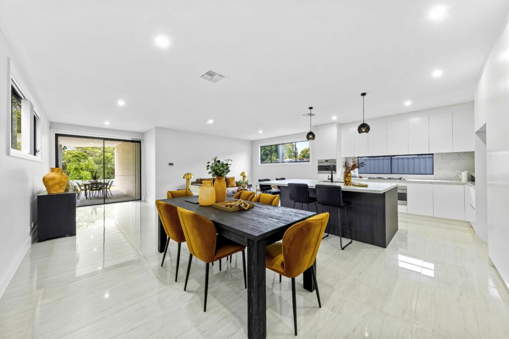 Large kitchen area with dining table and yellow chairs